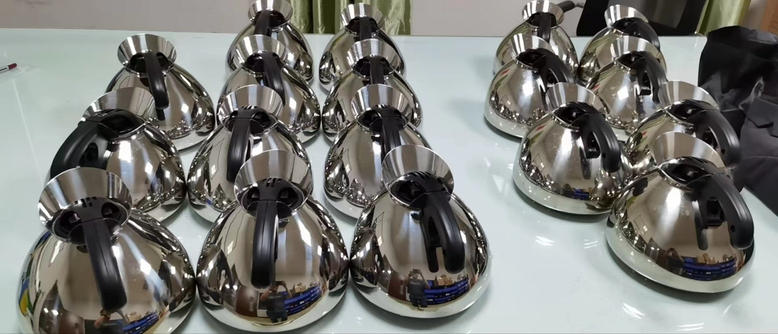 A production batch of polished Musical Tea Kettle bodies lined up together