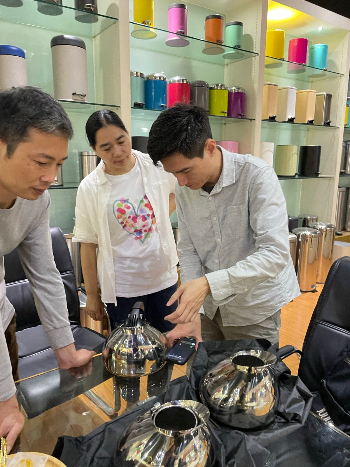 Team members reviewing Musical Tea Kettle prototypes and parts